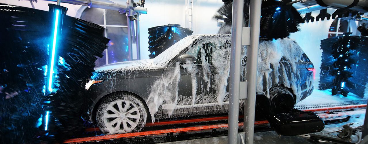 SUV covered in foam inside the express tunnel